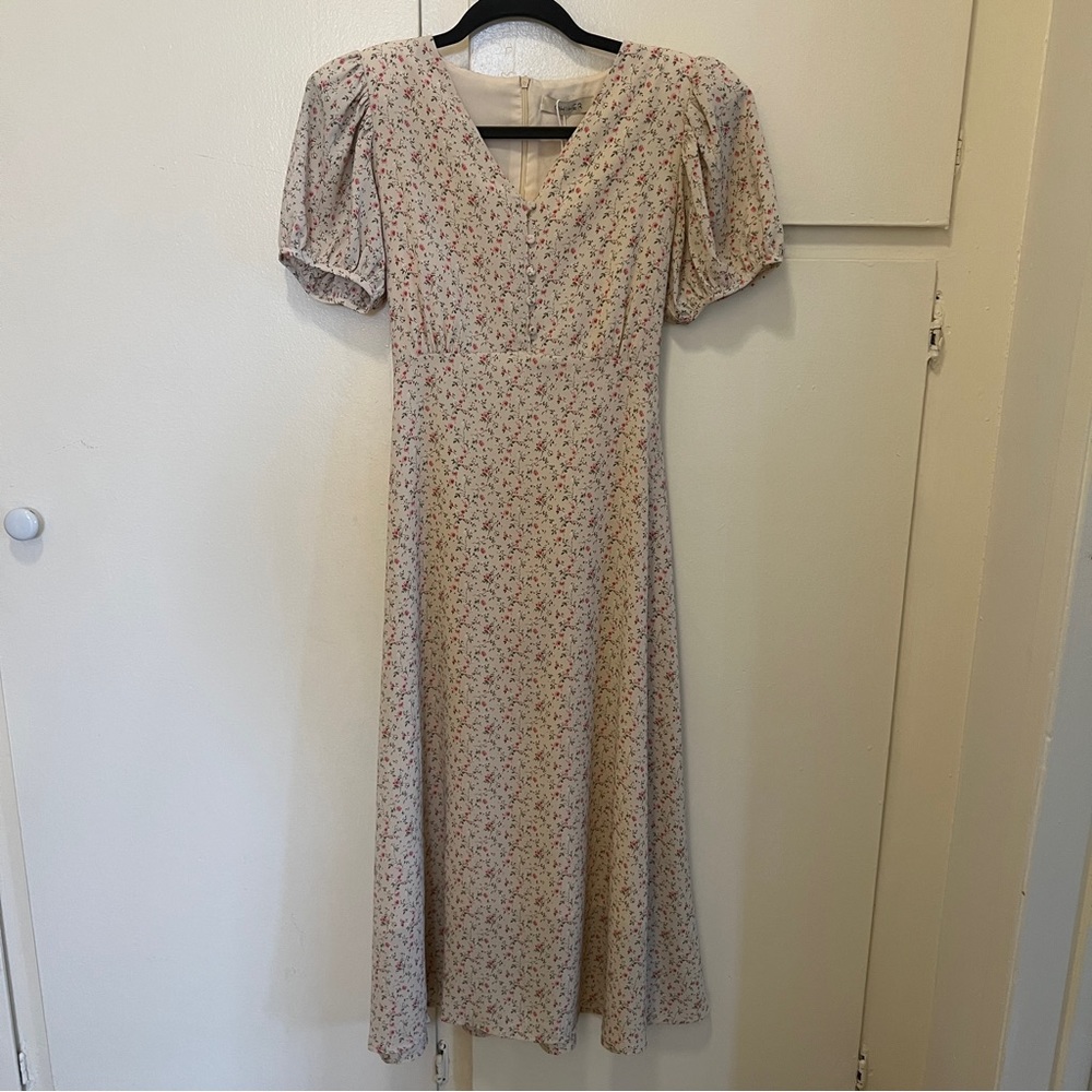 cream colored floral maxi dress with puff sleeves and shoulder pads